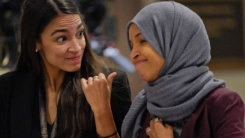 Rep.-elect Alexandria Ocasio-Cortez, D-NY., chats with Rep.-elect IIhan Omar, D-Minn., en route to member-elect briefings in Washington on November 15.